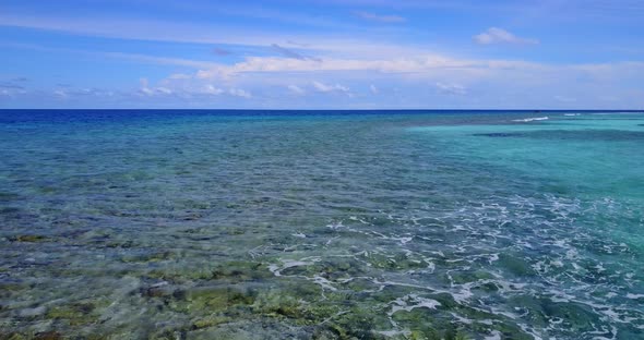 Daytime aerial copy space shot of a summer white paradise sand beach and aqua blue water background 