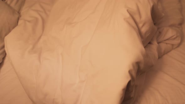 Top View of Mother and Daughter Having Fun Together Looking Out of Blanket in Bed at Night