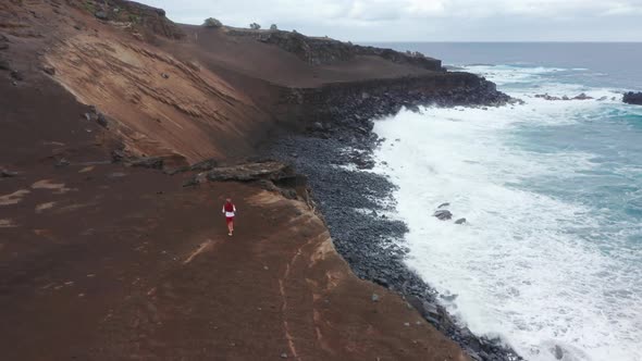 Sporty Man Running on Mountain Road of Capelinhos Volcano Faial Island Azores
