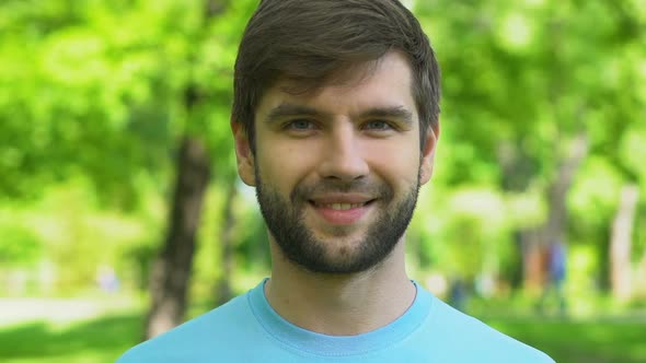 Bearded Male Smiling on Camera in Park, Love to Nature, Eco-Volunteer Concept