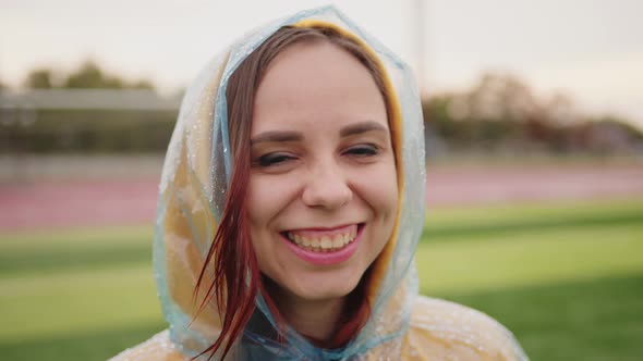 Young Woman in Raincoat in Rainy Weather