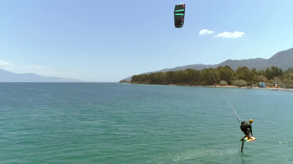 Aerial view of person kitesurfing in the Gulf of Patras, Greece.