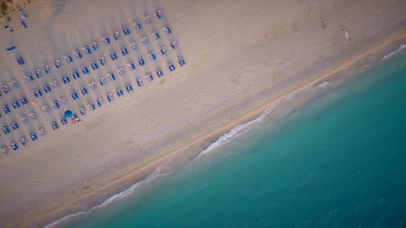 Aerial view of sun loungers on beach in Kathisma, Lefkas island, Greece.