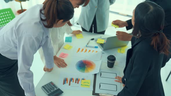 Business People Proficiently Discuss Work Project on Meeting Table