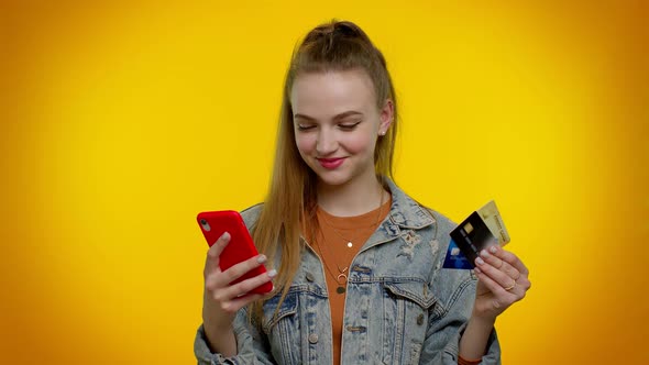 Teen Girl Using Credit Bank Cards and Smartphone While Transferring Money Purchases Online Shopping