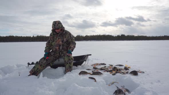 Fisherman Fishing on Frozen Lake