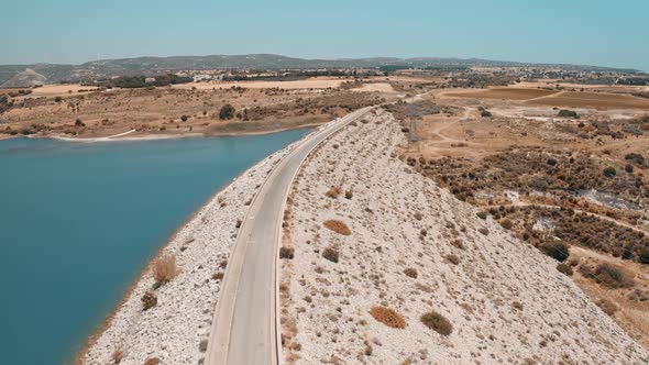 Drone View of Road in Mountain Suburb Desert Area Near Asprokremmos Reservoir in Cyprus