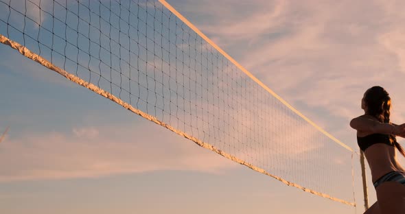 Group of Young Girls Playing Beach Volleyball During Sunset or Sunrise, Slow Motion,