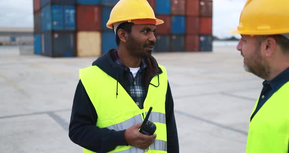 Multiracial engineer people controlling shipping containers inside industrial port