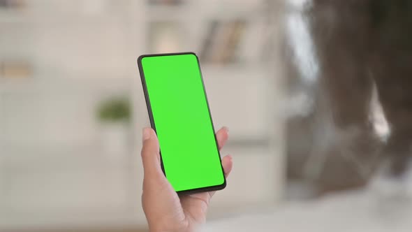 African Woman Using Smartphone with Green Chroma Key Screen