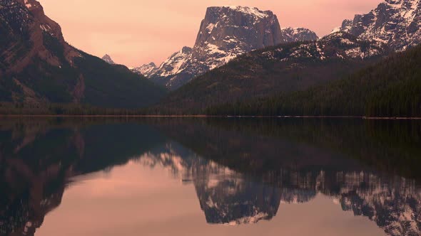 Static view of Square Top Mountain reflection in lake on ominous day