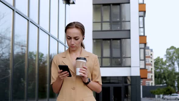 Confident Businesswoman walking on Parking near big modern Business district