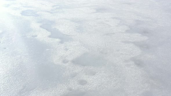Mountain lake under ice 4K aerial footage