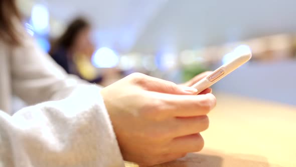 Woman using mobile phone at indoor