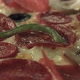 An almost cooked pizza is cooking while it's rotating in the oven. Close up. - VideoHive Item for Sale