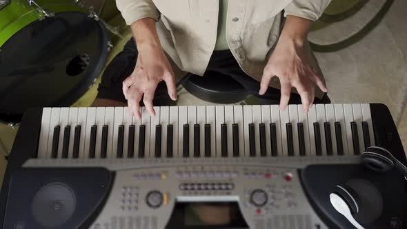 Young Man Plays Synthesizer in Equipped Music Studio