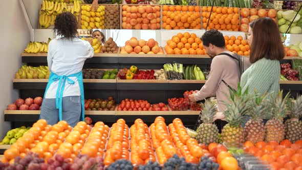 Diverse Buyers Choosing Vegetables in Farm Shop