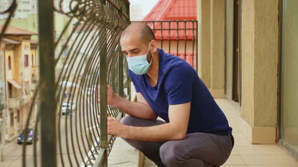 Man with Anxiety Problems Sitting on the Balcony