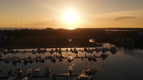 Aerial video of Grand Cayman Yacht Club Marina in the Cayman Islands at sunset