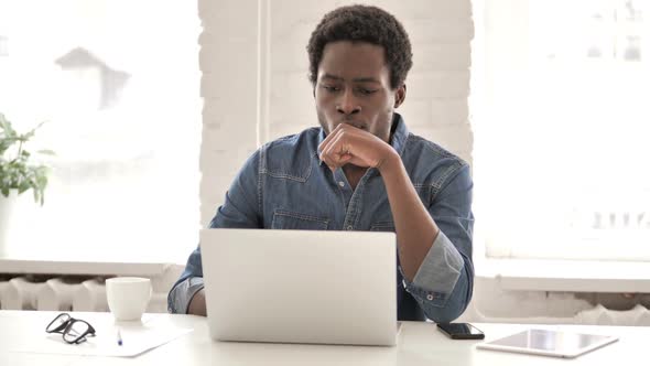 Pensive African Man Working on Laptop