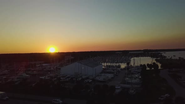 Drone flight over a marina on the Florida coast during sunset.