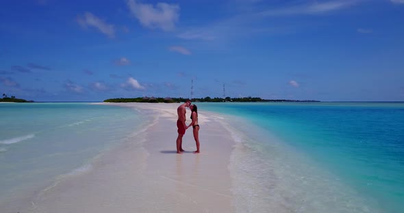 Young people in love dating on vacation enjoy luxury on beach on paradise white sand 4K background