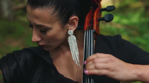 Female musician performs music outdoors. 