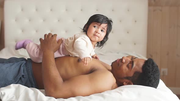 Young African American Father Smiling While Spending Time with Their Sweet Little Baby Girl