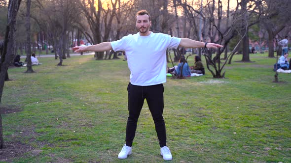 Man exercising in the park at sunset.