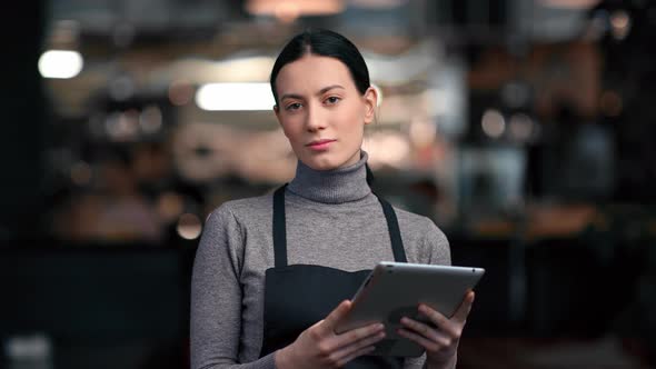 Asian Female Waitress in Apron Smiling Posing with Digital Tablet Order Menu