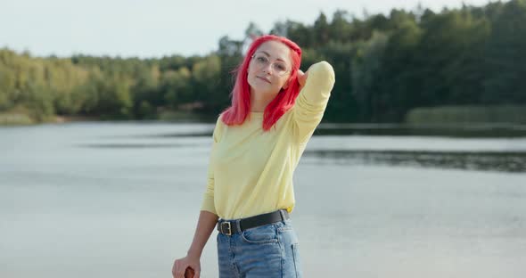 Beautiful Woman Corrects Combing Her Fingers Through Pink Hair Blown By Wind Has Glasses on Nose