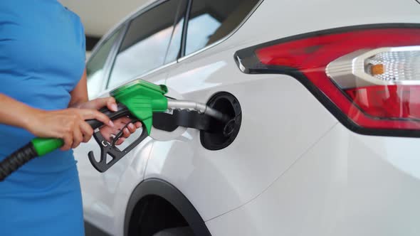 Woman Pulls Out a Refueling Gun From a Car Tank After Finishing Refueling