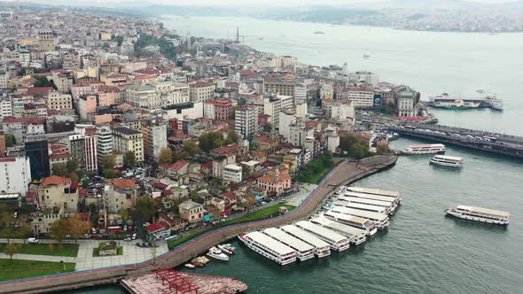 Wide aerial view of Taksim and Karakoy in Istanbul Turkey with ferry boats docked on the coast of th