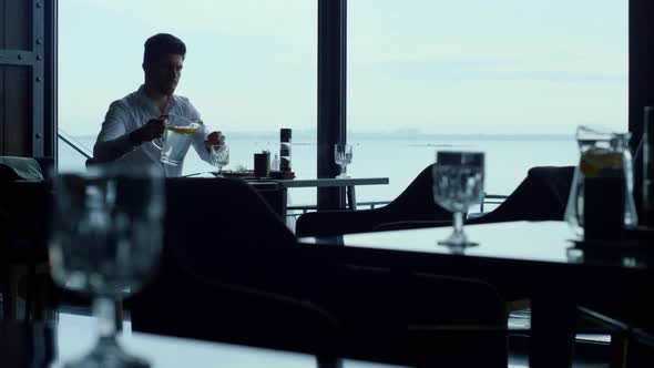 Attractive Entrepreneur Waiting Business Meeting in Stylish Restaurant Sea View