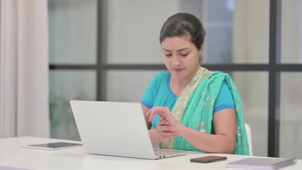 Indian Woman Having Wrist Pain While Using Laptop in Office