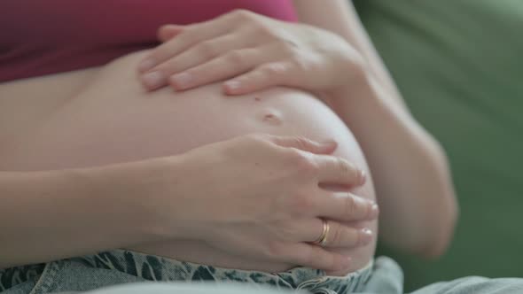 Close Up of Pregnant Woman Holding Her Big Abdomen Tummy