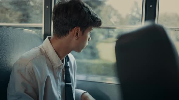 Indian Teenager Sitting Bus Looking Down Close Up