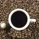 A Cup Of Black Coffee And Chocolate On A Background Of Rotating Coffee Beans. - VideoHive Item for Sale