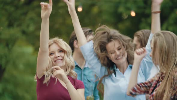 Happy Friends Dancing, Having Fun And Enjoying Party Outdoors.