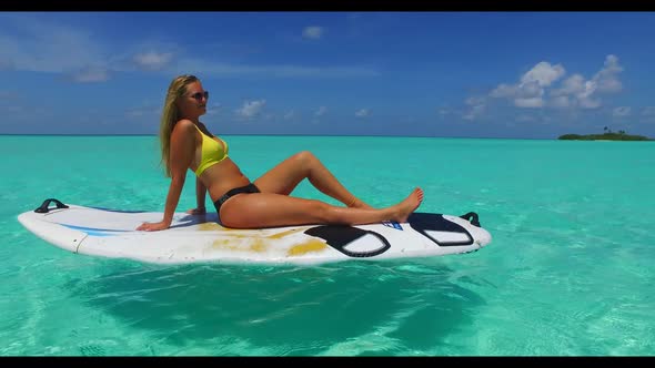 Beautiful ladies sunbathing on exotic shore beach lifestyle by turquoise ocean with white sandy back