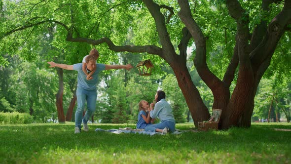 Smiling Family Have Fun Resting on Nature