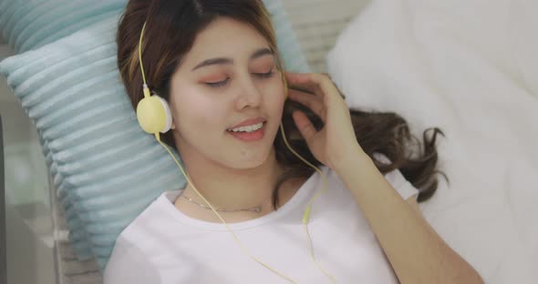 Close Up Happy Asian Woman Listening To Music By Headphones.