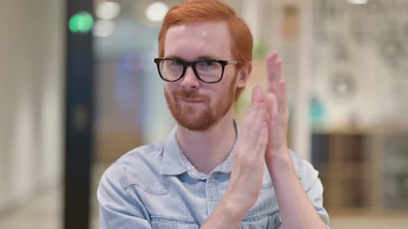 Excited Young Redhead Man Clapping Cheering