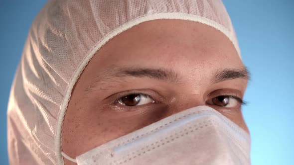 Caucasian Bearded Man in White Protective Suit Take Off Medical Mask From Face