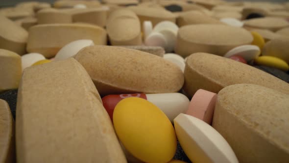 Pills in Medical Lab Moving Slowly Over Them in Close Up View