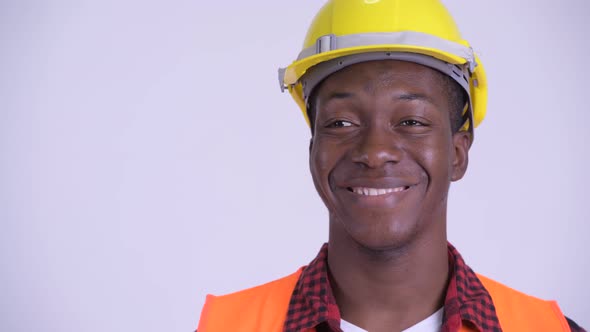 Face of Young Happy African Man Construction Worker Thinking