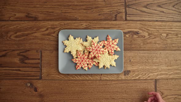 Close up of people eating Christmas cookies alt