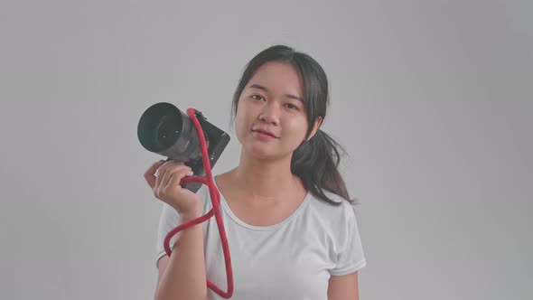 Young Asian Female Photographer Standing In Studio