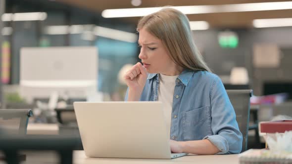 Sick Woman Coughing While Using Laptop in Office