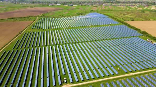 Aerial View of Big Sustainable Electric Power Plant with Many Rows of Solar Photovoltaic Panels for